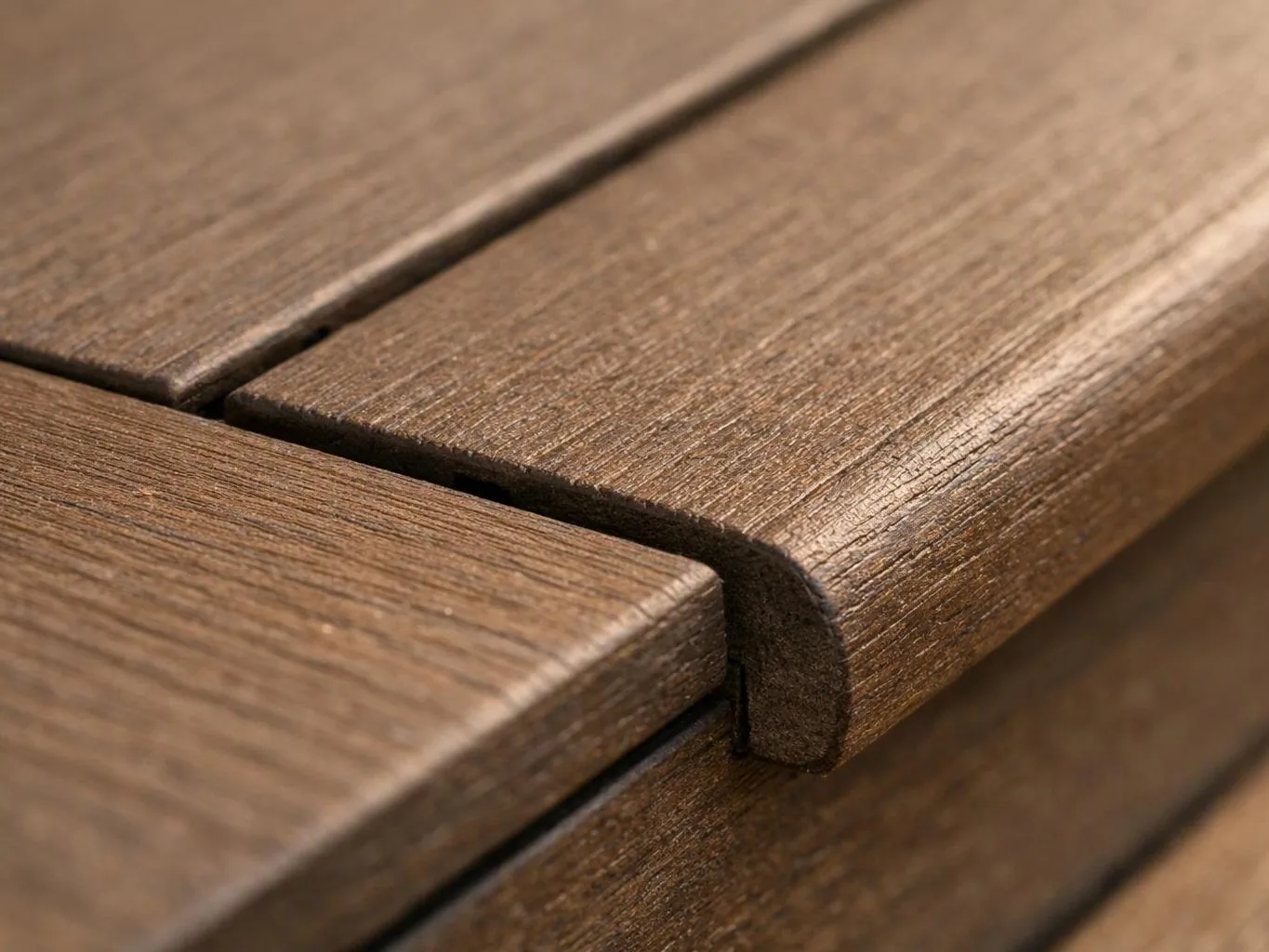 Close-up of brown wooden slats joined with a curved edge and visible grain texture
