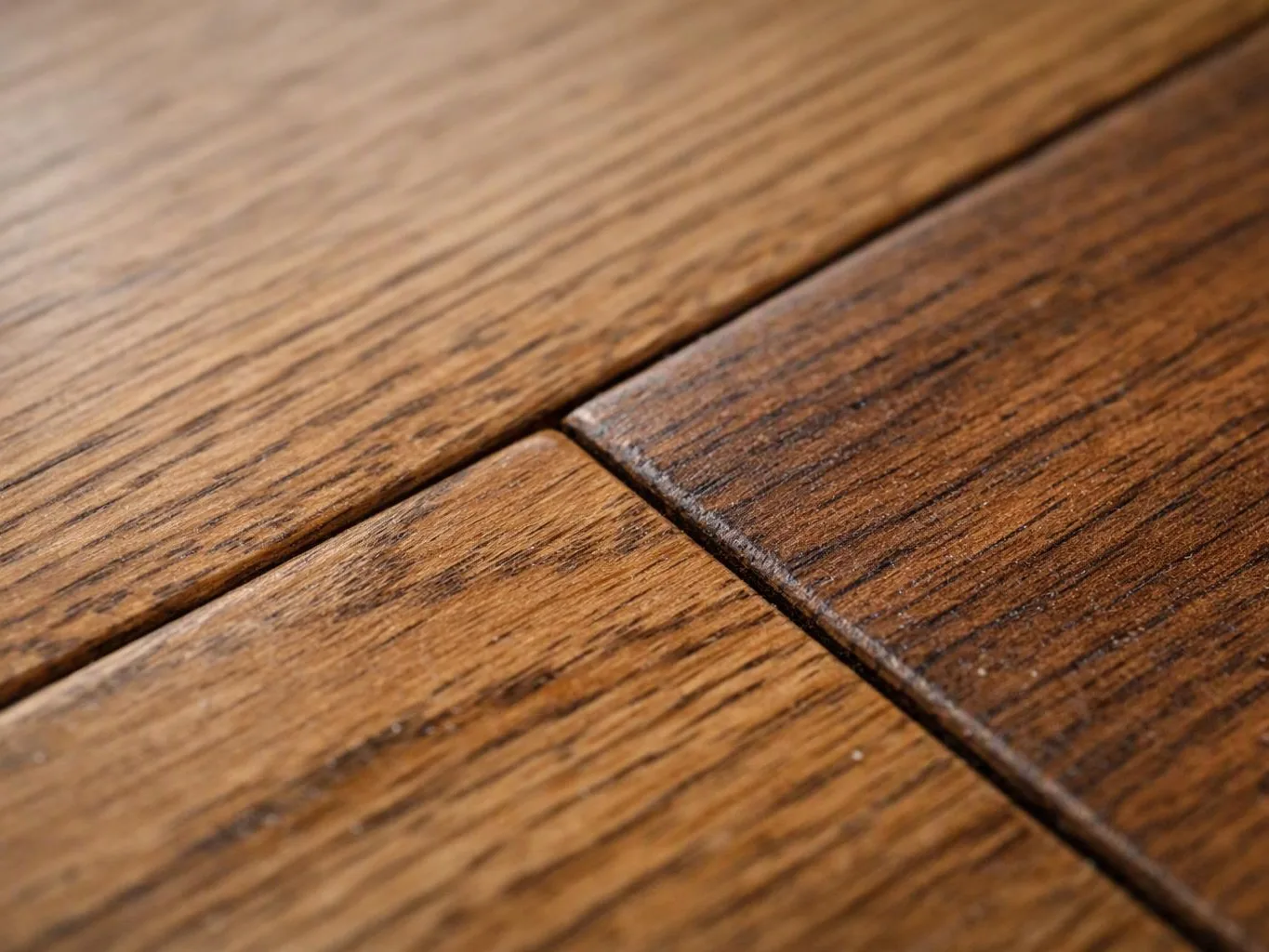 Close-up of wooden floorboards joined by visible seams and grain lines